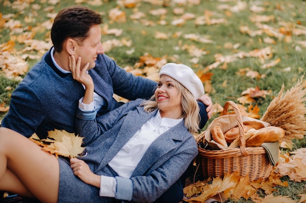 Happy couple enjoying golden autumn spring season in the park