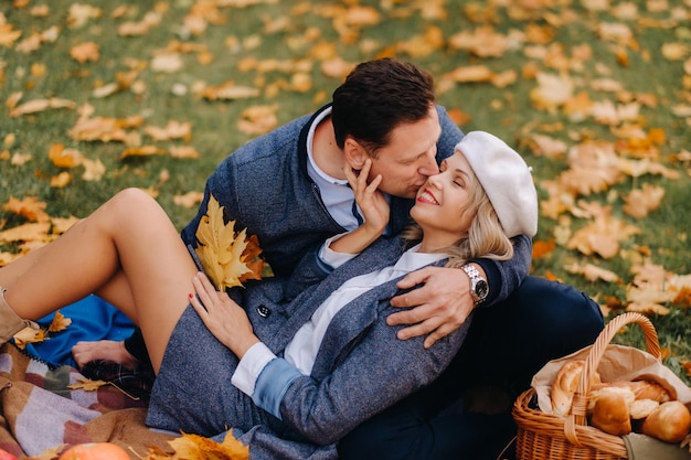 Happy couple enjoying golden autumn spring season in the park