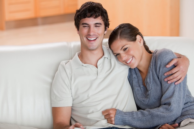 Happy couple enjoying their time together on the sofa