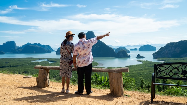 Happy  couple enjoying valley view from top of a mountain