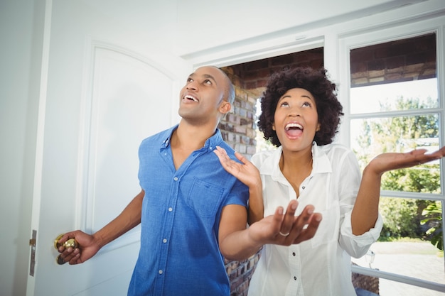 Happy couple entering in their house and cheering