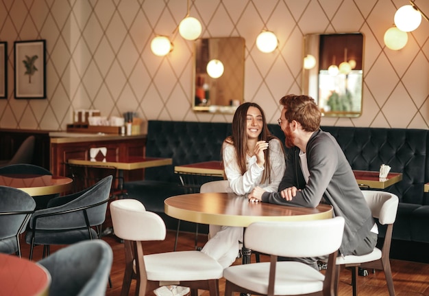 Happy couple flirting in cafe