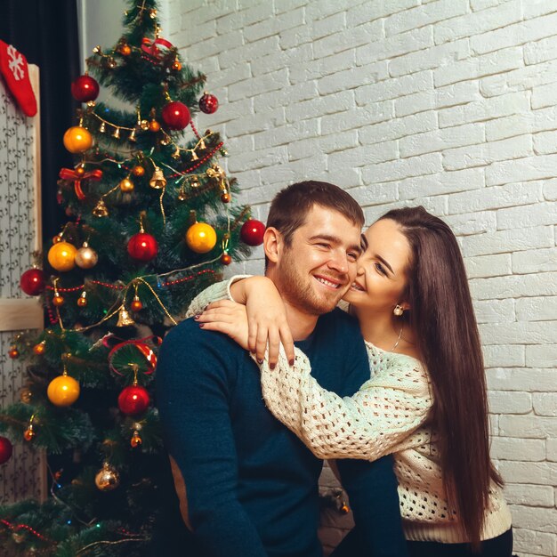 Happy couple flirting with each other New Year's Eve. Christmas mood.