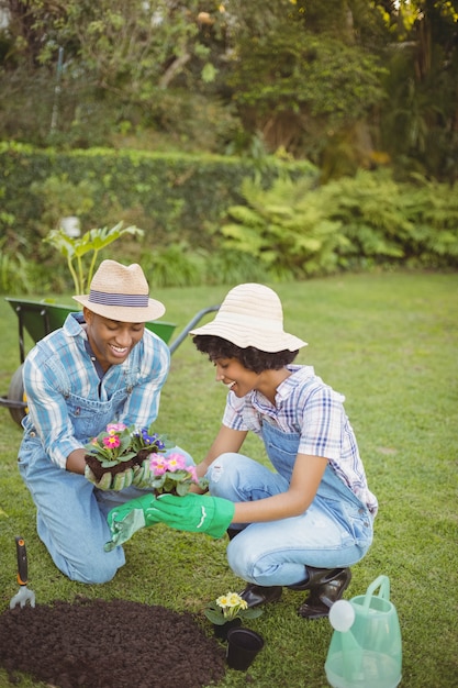 Happy couple in the garden holding flowers