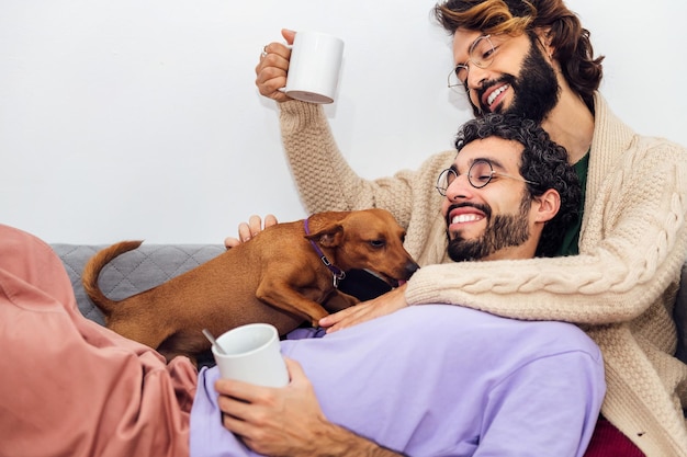 Happy couple of gay men relaxing on the sofa