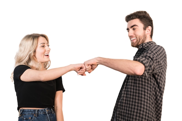 The happy couple greeting with fists on the white background