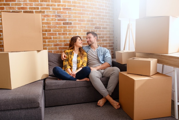 Happy couple have to move and arrange all the packages to new home