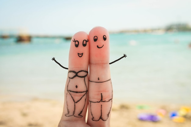 Happy couple have a rest on the beach in bathing suits 