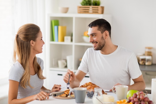 happy couple having breakfast at home