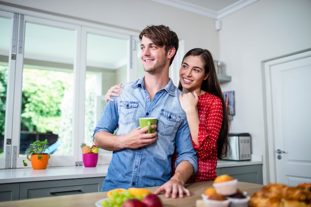 Happy couple having breakfast together at home