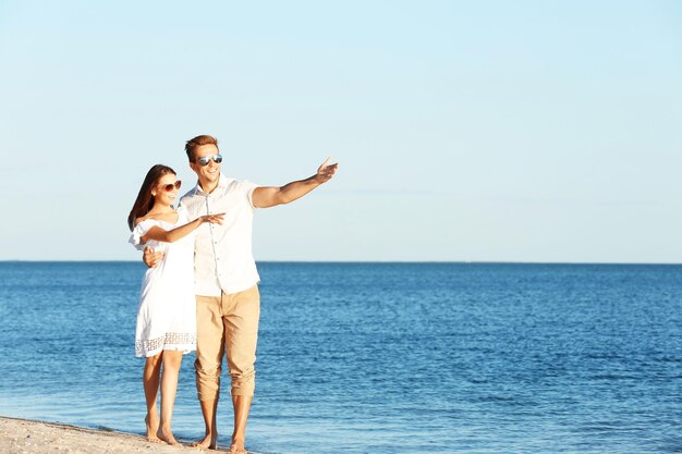 Happy couple having date on seashore