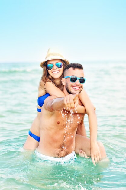 happy couple having fun at the beach