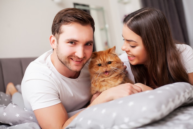 Happy couple having fun in bed. Intimate sensual young couple in bedroom enjoying each other