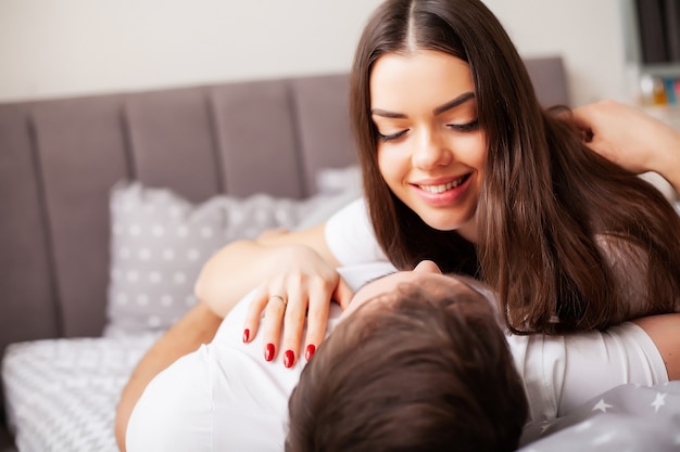 Happy couple having fun in bed