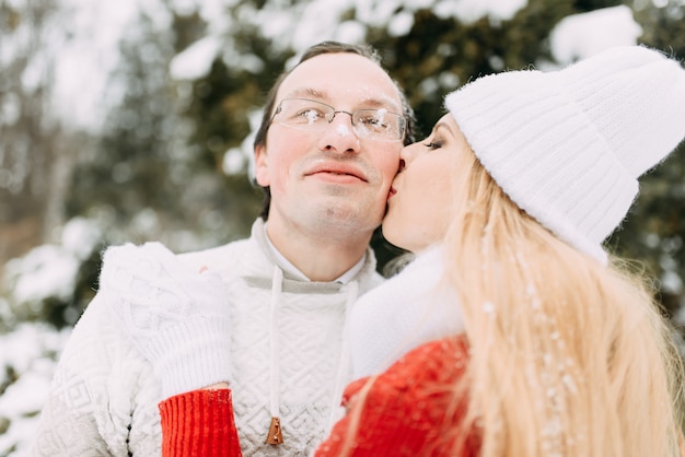 Happy Couple Having Fun Outdoors in Snow Park.