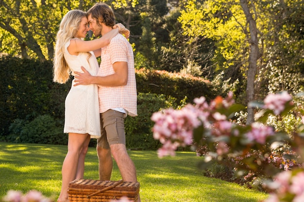 Happy couple having a picnic and embracing in the garden