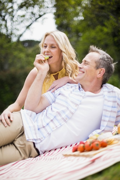 Happy couple having a picnic outside