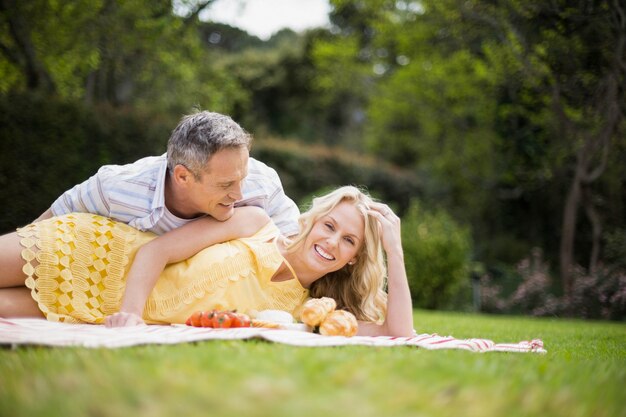 Happy couple having a picnic outside