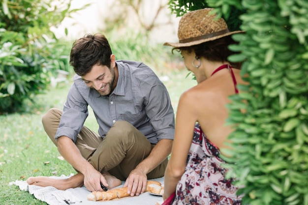 Happy couple having a picnic in a park