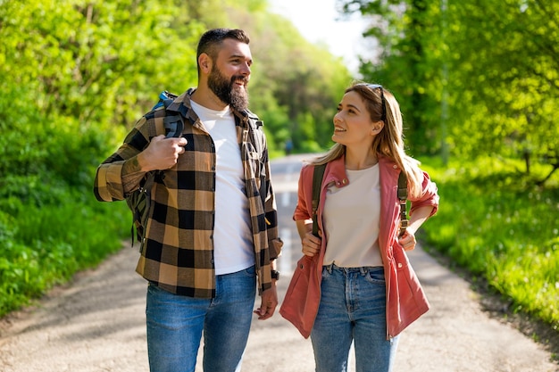 happy couple hiking in nature on sunny day couple enjoying their vacation