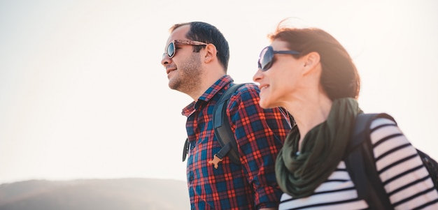 Happy couple hiking together on a mountain