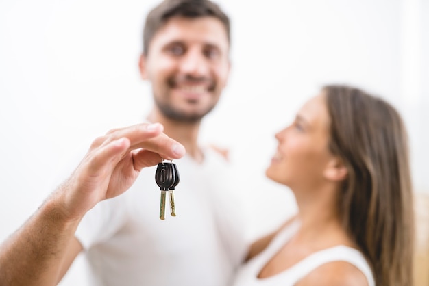 The happy couple hold keys