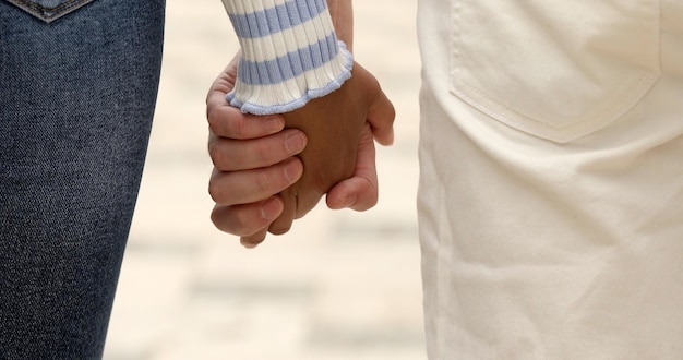 Happy couple holding hands in the sunset. Love, friendship concept.