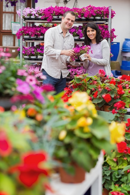 Happy couple holding purple flowers