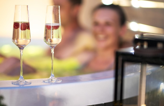 Happy Couple in Hot Tube with Champagne