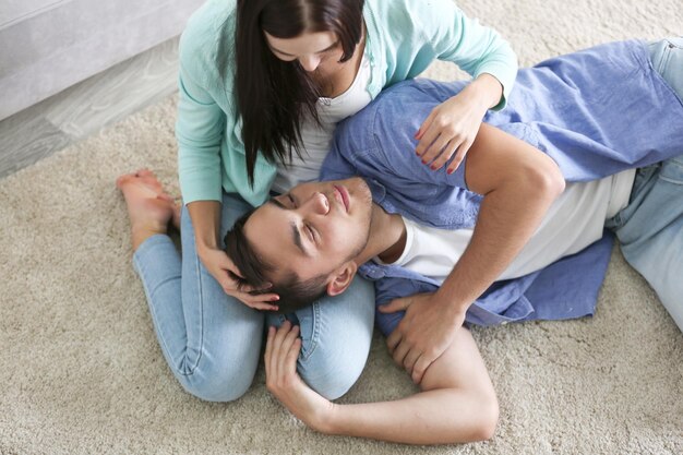 Happy couple hugging on floor