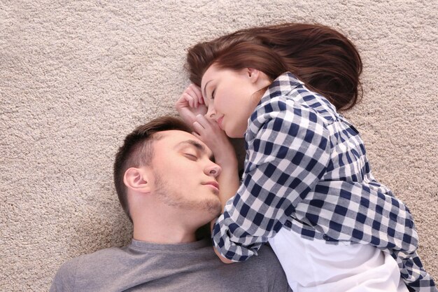 Happy couple hugging on floor