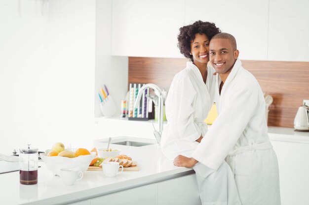 Happy couple hugging in the kitchen at home