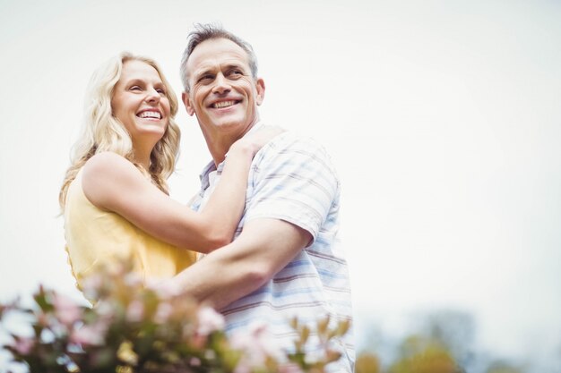 Happy couple hugging outside