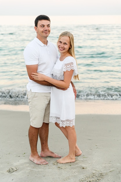 Happy couple hugging on the seashore  .  romantic time. happy young people.