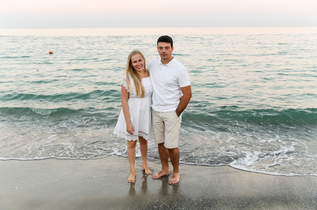 Happy couple hugging on the seashore  .  romantic time. happy young people.