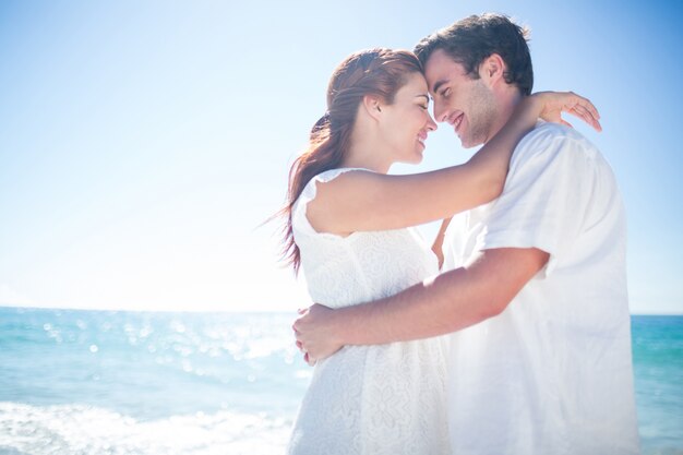 Happy couple hugging and smiling at each other