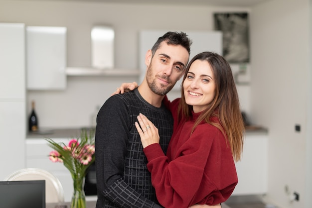 Happy couple hugging in their home