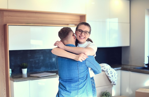 Happy couple hugging in their new house