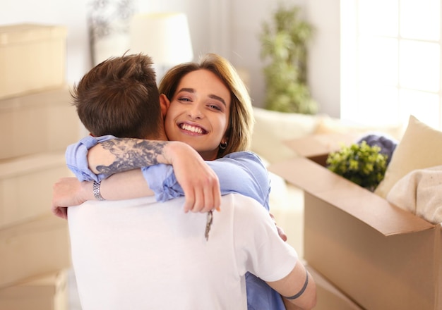 Happy couple hugging in their new house