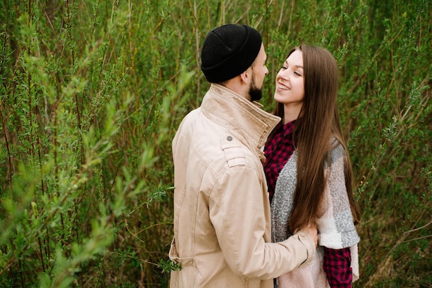 Happy couple hugs each other on the green nature background