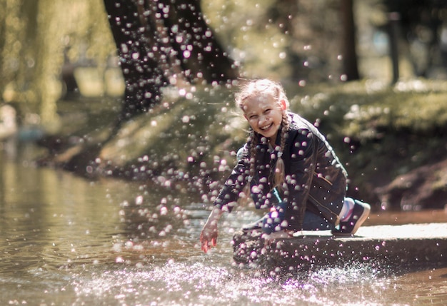 Happy couple of kids playing by the lake happy childhood