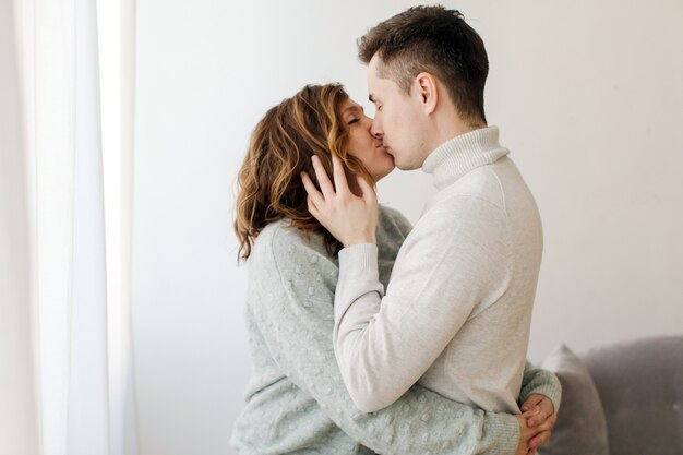 Happy couple kissing at home