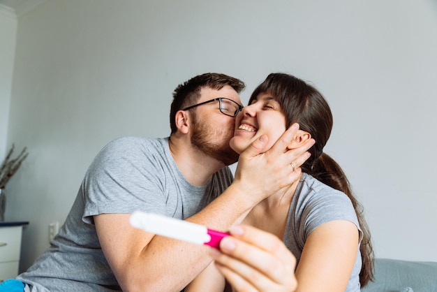 Happy couple looking on pregnancy test