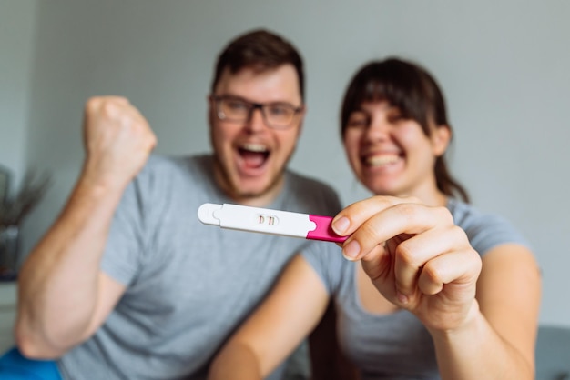 Happy couple looking on pregnancy test