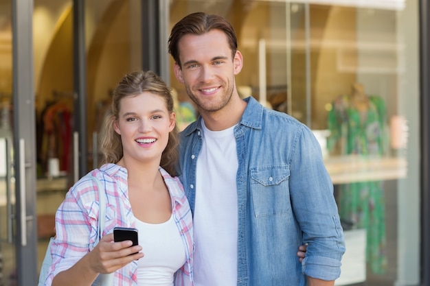 Happy couple looking at smartphone