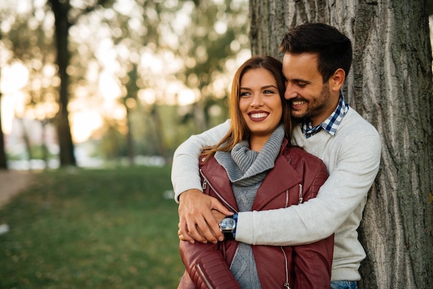 Happy couple in love cuddling in the park