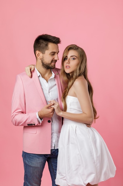 Happy couple in love embracing on pink background st valentines day