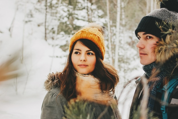 The happy couple in love at the forest nature park in cold season