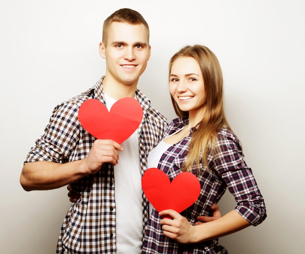 Happy couple in love holding red heart.