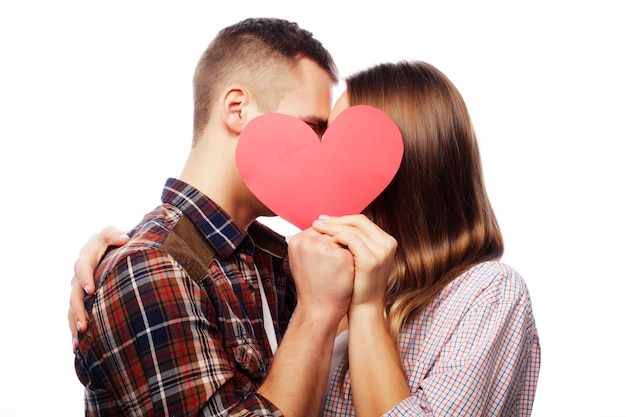 Happy couple in love holding red heart.